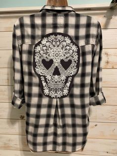 a black and white checkered shirt with a skull on it