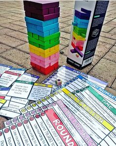 a stack of colorful building blocks sitting on top of a sidewalk