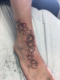 a woman's foot with a tattoo design on the top and bottom of it