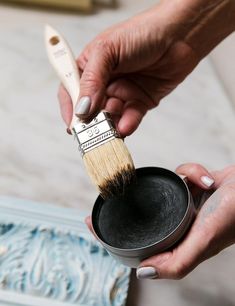 a person holding a paint brush in their hand