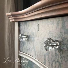 a close up of a cabinet with glass knobs