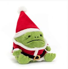 a green stuffed animal wearing a santa hat