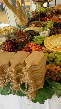 a table with many different types of food on it, including cheeses and crackers