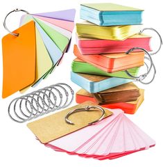 a stack of binders, paper and scissors on a white background