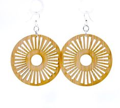 pair of bamboo earrings with circular cutouts on them, hanging from silver earwires