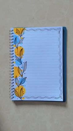 an open notebook with yellow and blue flowers on it