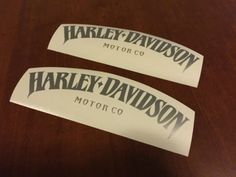 two harley davidson motor co decals on a table