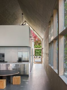 an open kitchen and dining area with large windows