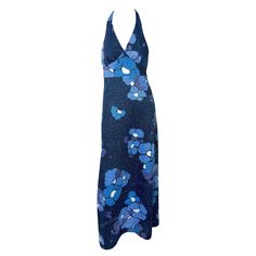 Presenting a dazzling blue floral Paco Rabanne halterneck gown from the 1970s. This luminous lurex gown boasts a metallic blue floral pattern throughout. Its floor-length design includes a deep v-neckline, halter neck tie, and a partially exposed back. Approximate measurements: Size - removed Bust: Free Under bust: 30 - 34" Waist: 34 - 36" Hips: 40 - 44" Top of bust to hem: 58.5" 90% Polyester, 10% Lurex Tank Dresses, Blue Floral Pattern, Metallic Blue, Paco Rabanne, Fashion Boutique, Fashion Store, Blue Floral, Day Dresses, Vintage Shops