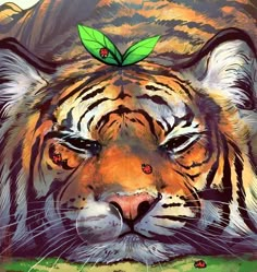 a painting of a tiger with a green leaf on its head