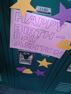 a happy birthday sign is posted on a locker in a school hallway, with stars and confetti all over it