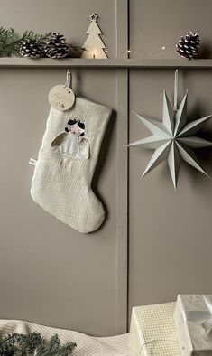 a christmas stocking hanging on the wall next to a star ornament and other decorations