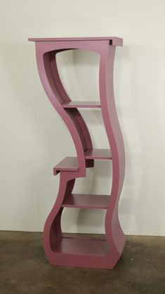 a pink shelf sitting on top of a floor