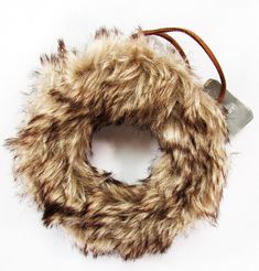 a fur wreath with a leather cord on a white background