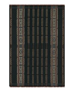 a black and brown striped rug with an intricate design on the bottom, in front of a white background