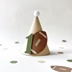 a paper party hat with a football on it