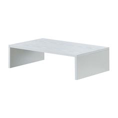 a white coffee table sitting on top of a white floor