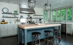 a kitchen with an island and stools in it