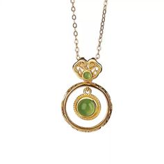 Material: S925 Sterling Silver with Gold PlatingGemstone: Jade, approximately 5mm (large), 2mm (small)Weight: Approximately 1.5gSize: Pendant Length: 22mm, Width: 15mm Description:Embrace timeless elegance with this Jade Double Circle Pendant Necklace. The design features a larger jade gemstone encased in a delicately twisted gold-plated S925 sterling silver frame, complemented by a smaller jade accent at the top. The double-circle structure offers a unique aesthetic that merges modern minimalism with traditional charm. This lightweight necklace is perfect for everyday wear, adding a refined touch to any outfit. The green jade's natural luster provides a subtle yet captivating appeal, making this piece an essential addition to your jewelry collection. Note: As jade is a natural gemstone, s Elegant Jade Necklace For Formal Occasions, Jade Clavicle Chain Pendant Jewelry, Formal Jade Necklace With Round Pendant, Elegant Jade Necklaces As Gifts, Elegant Jade Necklaces For Gifts, Elegant Jade Necklace For Gifting, Elegant Jade Necklace As Gift, Elegant Jade Necklace Round Shape, Elegant Jade Round Necklace