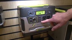 a person is pressing the button on an appliance in a room with wood paneling