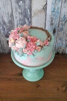 a birthday cake with pink flowers on top and the words happy birthday written across it