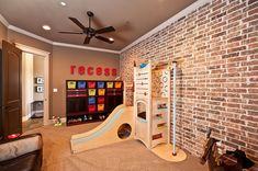 a child's play room with a slide and climbing wall