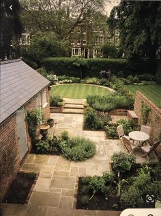 an outdoor garden is shown in the middle of a yard with lots of greenery