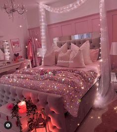 a bedroom with pink walls and lights on the ceiling