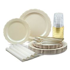 a table setting with plates, silverware and napkins on the plate stand next to each other