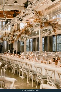 a long table is set up with white linens and gold decorations for an event