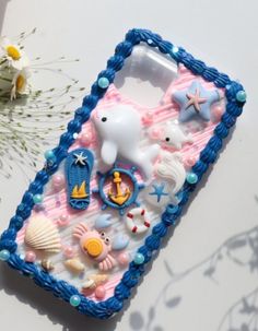 there is a cell phone case made out of plastic and decorated with sea animals on it