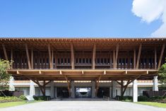 a large wooden building with lots of windows on top of it's sides and balconies above the entrance