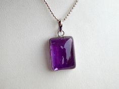 "Amethyst Designer Pendant. Exquisite Pendant is beautifully and Traditionally Hand Crafted into a beautiful design.  Stone: Amethyst Material : 925 Sterling Silver (1 gram approx.) Total Weight: 10.44 grams approx. Stone Shape: ractengular Shape  Stone Setting: Bezel Setting  Product is handmade with pure 925 Sterling silver.  Genuine/Natural gemstones were used. We don't deal with laboratory generated stones.  Please understand that the natural gemstone is unique and may vary in shape or color.  Photos were taken in natural light for the listed item. However, since screen resolutions may vary, the colors \"in-person\" may be slightly different than you see on your monitor.   Any Queries and questions are most welcome. We will answer your precious queries with utmost urgency. Amethyst Cabochon Necklace For Gift, Purple Necklace With Polished Finish As Gift, Purple Cabochon Gemstones For Gift, Amethyst Cabochon Gemstones For Gift, Purple Cabochon Necklace For Gift, Amethyst Pendant Necklace, Amethyst Necklace Pendant, Stone Setting, Cabochon Pendant