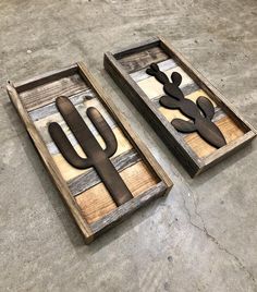 two wooden utensils sitting on top of a cement floor next to each other