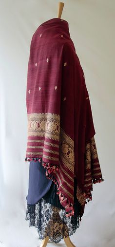 A hundred percent Eri Silk Shawl that can also be used as a Dupatta to complement your Indian Ethnic suits.  The motifs are woven in Ghica silks . The motifs are typical of the region and are widely used in the traditional wear.  Since Eri Silk is there, the stole / dupatta does not have the typical sheen that is associated with Silks from India.  Eri Silk is an indigenous Silk variety from India found in Assam and some other North Eastern States. Eri Silk is the original Assam Silk. The lack of Red Bohemian Shawl With Pallu, Bohemian Shawl With Motifs For Diwali, Bohemian Dupatta With Woven Motifs For Festive Occasions, Bohemian Traditional Wear Shawl With Motifs, Bohemian Shawl With Pallu For Festive Occasions, Festive Pashmina Dupatta With Woven Motifs, Traditional Wear With Woven Motifs For Festival, Bohemian Embroidered Tussar Silk Fabric With Traditional Patterns, Bohemian Tussar Silk Fabric With Traditional Embroidery