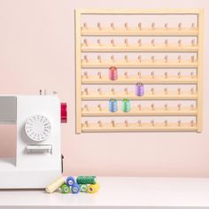 a sewing machine sitting on top of a table next to a wall mounted pegboard