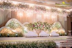 an elaborate wedding setup with flowers and candles