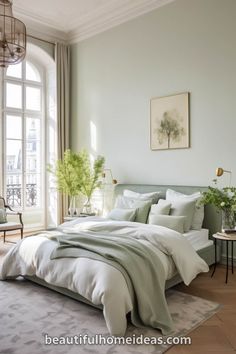 a bedroom with a large bed and lots of windows