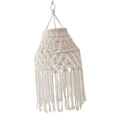 a white macrame hanging lamp with fringes