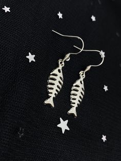 Cute fish skeleton earrings! Comes on hypoallergenic tarnish-resistant ear hooks :) LENGTH: 1.5 inches MATERIALS: Silver fish skeleton charms, stainless steel jump rings, stainless steel ear hooks SHIPPING: FREE to U.S. I'll take care of the shipping cost for you! All orders ship with USPS First-Class Mail (3-7 days delivery time). I will send your package out within 2-3 days after you place your order. Have any questions? Send me a message and I'll do my best to respond ASAP.  Thank you for loo Fish Bone Earrings, Physical Manifestation, Fish Hook Jewelry, Fish Skeleton, Skeleton Earrings, Bone Earrings, Metal Fish, Cute Fish, Silver Fish