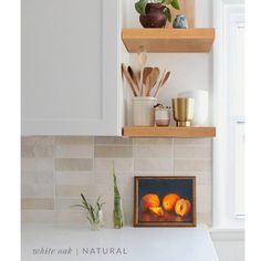 two shelves above a kitchen counter with utensils