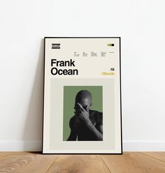 a black and white poster sitting on top of a wooden floor next to a wall