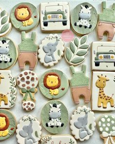 many decorated cookies with animals and giraffes on them