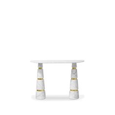 a white marble table with gold trimmings and two small round pedestals on each side