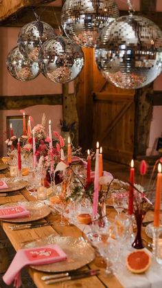 a long table with plates and candles on it