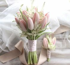 a bouquet of pink tulips and baby's breath