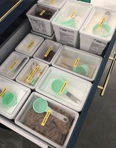 several plastic containers filled with food on top of a counter next to other containers and spoons