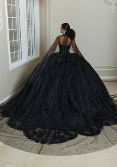 We are obsessing over this all black Quinceanera that just screams uniqueness! 89482, is a stunning ballgown with a blingy corset bodice that will accentuate your waistline and have you sparkling all night long. The delicate lace details that flow onto the sparkling tulle skirt that's completed with a petal train and lets not forget about the mesmerizing bow on the back! This is perfect for your Quince day! For additional details on this ballgown, give us a call at Terry Costa or chat with us! All Black Quinceanera, Glamorous Fitted Ball Gown For Quinceanera, Glamorous Fitted Quinceanera Dress For Debutante Ball, Glamorous Fitted Gown For Quinceanera, Elegant Fitted Quinceanera Dress With Corset Back, Fitted Quinceanera Dress With Corset Back For Gala, Fitted Black Quinceanera Dress, Black Ball Gown With Boned Bodice, Black Wedding Ball Gown With Boned Bodice