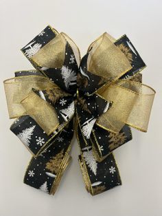 a black and gold bow with snowflakes on it