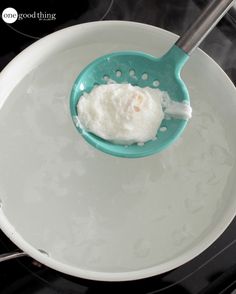 a spoon with some food in it on top of a stove burner that is cooking